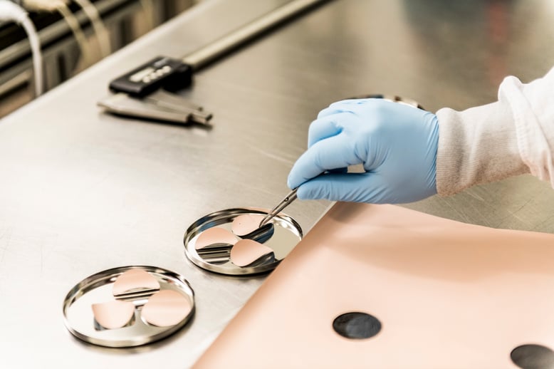 Tapemark employee conducting drug coating for transdermal drug delivery